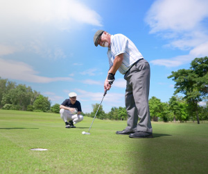 An elderly group of Asian men enjoying a round of golf