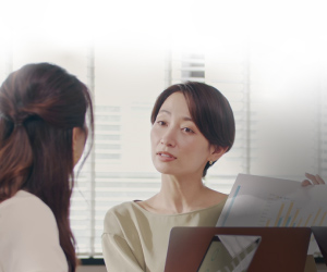 An Asian female consulting with an Asian female.